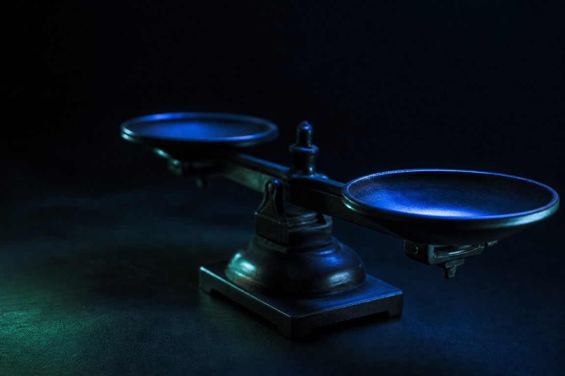 A mechanical balance scale with two empty pans