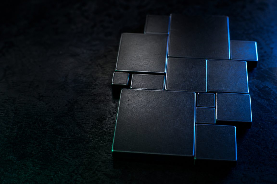 Blank square metal plates of differing sizes packed edge to edge