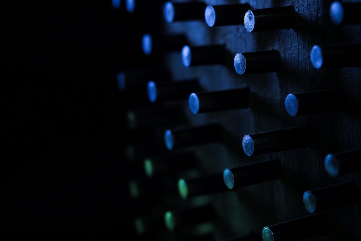 A dark board of protruding steel pins in a staggered grid
